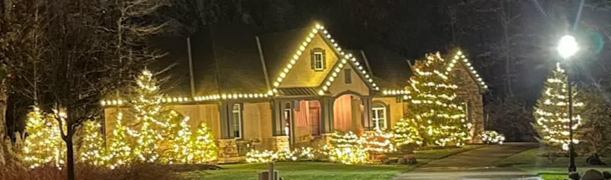 Evening exterior with lit garland and entryway wreath